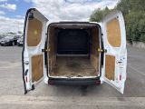 the back of a white van with its doors open in a parking lot