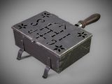 a small metal box with a handle on a table