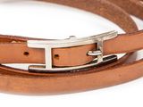 a close up of a brown leather belt with a silver buckle