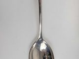 two spoons that are sitting on a table