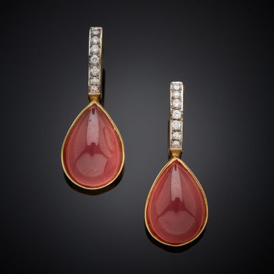 a pair of coral and diamond earrings