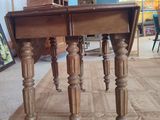 a small table with a wooden top on a wooden floor