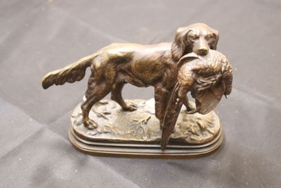 bronze figurine of a dog with a duck in its mouth