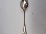 a spoon that is sitting on a white surface