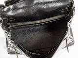 an image of a black purse on a white surface
