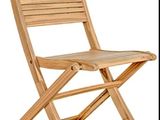 the chair is made of teak wood and has a slatt back
