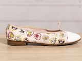 a close up of a pair of shoes with hearts on them