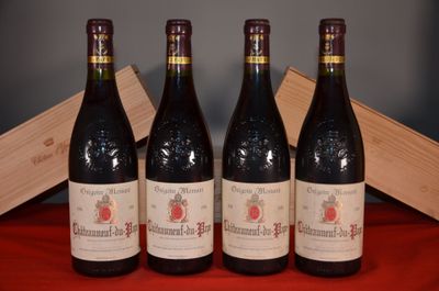 three bottles of red wine sit on a red cloth next to a wooden box