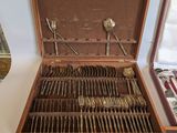 a wooden case with silverware in it on a table