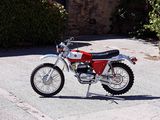 a red and white dirt bike parked on the side of the road