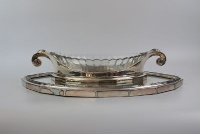an antique silver plate with a glass bowl on a tray