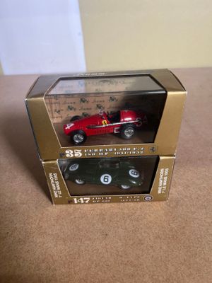 a red toy car in a box on a table