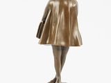 a bronze statue of a woman in a hat and dress