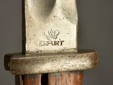 a close up of a knife on a wooden stand