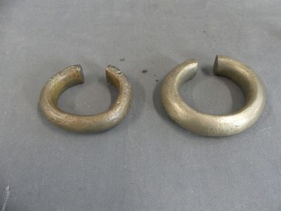 pair of antique brass hoop earrings on a gray surface