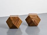two wooden cubes sitting on top of a cement floor