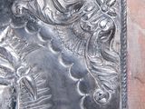 a metal plaque with a horse and a bird on it