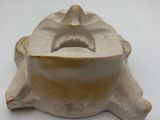 a small white object on a white surface that looks like a face