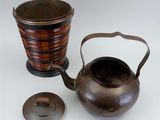 a tea pot and a tea kettle sitting next to each other