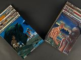 three children ' s books are lined up on a black surface