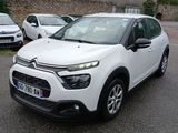 a white citrole parked in a lot next to other cars