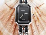 a close up of a watch with a chain around it