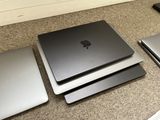 three laptops are sitting on the floor next to each other