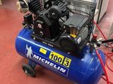 a blue air compressor sitting on top of a red floor