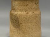a brown vase that is sitting on a table