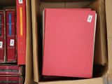 many books in a box on the floor next to each other