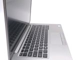 a silver laptop computer sitting on top of a white table