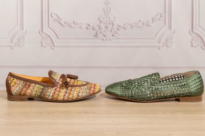 two pairs of shoes are sitting on a wooden floor