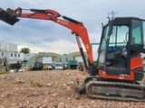 a small excavator that is sitting in the dirt