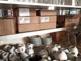 many cups and saucers on the counter in the kitchen