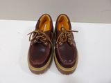 pair of red and brown leather shoes on a white surface