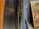 a picture of a painting on the wall next to a refrigerator