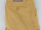 a close up of a pair of tan pants on a white surface