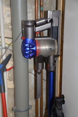 an image of a blue and silver vacuum in a room
