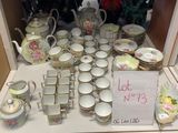 a lot of china on a table with a price sign