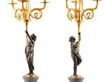pair of bronze and marble candelabs with figures on pedestals