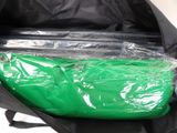 a black bag with a green bag inside of it