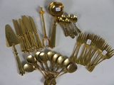 many different types of silverware on a white table