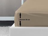 an image of a bed with a brown cover and a black arrow pointing to the bottom