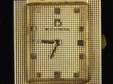 an image of a gold watch on a black background