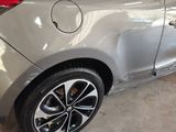 a car that has been painted silver and is parked in a garage