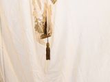 a picture of a curtain with a tassel hanging from it