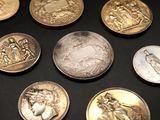 a lot of coins that are on the table