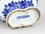 a blue and white vase with a gold rim on it