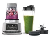 a blender with a green smoothie and a blender with a blender in it