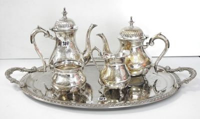 a silver tray with a silver tea set on it